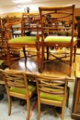 A VINTAGE DRAW-LEAF DINING TABLE and a set of six non-matching antique dining chairs