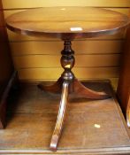 A REPRODUCTION TRIPOD TABLE WITH CIRCULAR TOP