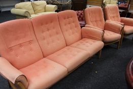 A GOOD ERCOL BLONDE THREE-PIECE SUITE with detachable buttoned orange upholstered cushions