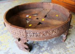 AN AFRICAN CARVED CIRCULAR SPICE GRINDER