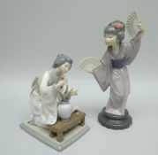 A LLADRO PORCELAIN SCULPTURE OF A DANCING GEISHA with decorative fans in each hand and long