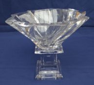 A BACCARAT CRYSTAL GLASS PEDESTAL BOWL the bowl of swirl form on a stepped square columnal base,