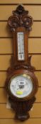 A VINTAGE CARVED BANJO ANEROID BAROMETER