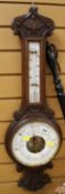 A CARVED OAK ANTIQUE BANJO ANOROID BAROMETER