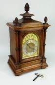 A WINTERHALDER AND HOFFMEYER BLACK FOREST ARCHITECTURAL BRACKET CLOCK in oak with brass dial and