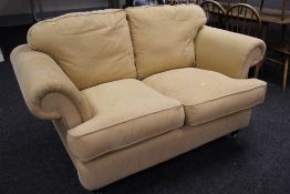 MODERN TWO SEAT SOFA having scroll arms in ribbed mustard coloured upholstery