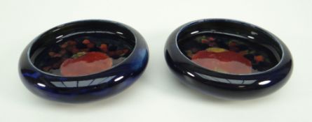 PAIR OF MOORCROFT POTTERY BLUE GROUND CIRCULAR DISHES (2)