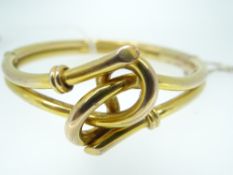 9CT YELLOW GOLD BANGLE with knot design to the centre, 13gms