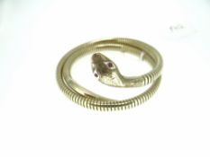 9CT YELLOW GOLD SNAKE FORM BANGLE with incised scale decoration to the coiled gas pipe body and with