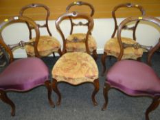 SET OF FOUR VICTORIAN DELICATE DINING CHAIRS OF CARVED BALLOON FORM with stuff-over cushion seats;