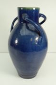 LARGE EWENNY POTTERY VESSEL having three looped handles decorated in mottled and shaded blue glaze