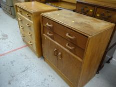 TWO MID-CENTURY OAK G-PLAN CHESTS one with cupboard base, the other with four graduated drawers