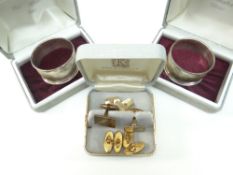 PAIR OF INDIVIDUALLY CASED SILVER NAPKIN RINGS together with a pair of 9ct yellow gold machine-