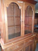 MODERN LIGHT OAK EFFECT CUPBOARD CABINET with glazed top, cupboard base and centre drawers, 200cms