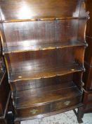 GOOD VINTAGE POLISHED OPEN BOOKCASE having four shelves of graduated depth, and two base drawers,