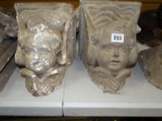 TWO VICTORIAN STONE WORK MAQUETTES OF ANGEL HEADS on a square base (one plaster, one stone)