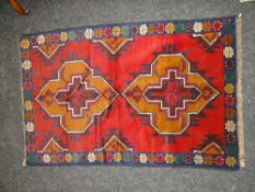 BALUCHI RUG, blue and red ground with a geometric design, 138 x 89cms