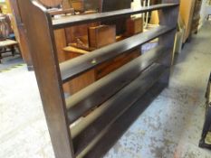 DARK STAINED PINE NARROW BOOKCASE with five shelves, 140cms high x 180cms wide, together with an