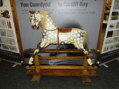 VINTAGE ENGLISH ROCKING HORSE with painted mottled body, with main, saddle and stirrups to a pine