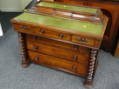 MAHOGANY DESK having flanking barley-twist columns, three graduated drawers and a work top with a