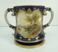 ROYAL WORCESTER PORCELAIN TWIN HANDLED LOVING CUP having a painted panel of cattle watering,
