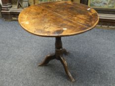 NINETEENTH CENTURY ELM CIRCULAR TOP TRIPOD TABLE, 73cms diam.