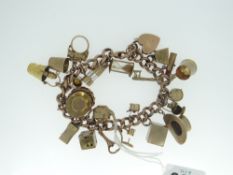 YELLOW GOLD CHARM BRACELET & CHARMS with heart shaped padlock hallmarked 9ct, 48gms gross