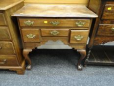ANTIQUE REGENCY STYLE MAHOGANY LOWBOY having a bank of four drawers and on ball and claw cabriole