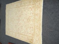 PALE CREAM & BROWN WOOLEN RUG with flower design in a centre square, 198 x 245cms
