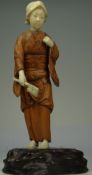 JAPANESE MEIJI PERIOD IVORY AND BOXWOOD FIGURE wearing fruit engraved kimono, with axe in her