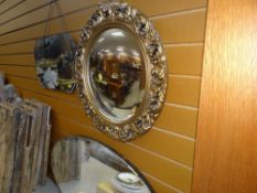 A VINTAGE OVAL GILT PLASTER ACANTHUS LEAF WALL MIRROR together with two other vintage wall mirrors