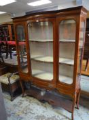 EDWARDIAN BOW-FRONT DISPLAY CABINET having inlaid decoration, centre drawer and single door and