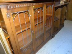 ANTIQUE REPRODUCTION CARVED THREE DOOR GLAZED BOOKCASE, together with a similar open bookcase and