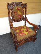 NINETEENTH CENTURY LOW COUNTRIES CARVED ARMCHAIR having floral tapestry feet and back
