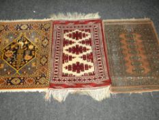 THREE VARIOUS PATTERNED WOOLEN PERSIAN PRAYER RUGS, 69 x 94cms, 94 x 67cms and 82 x 92cms