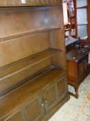 VINTAGE DARK OAK CUPBOARD BOOKCASE with three shelves and a two door cupboard base, 138cms high,