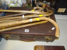 VINTAGE MONOGRAMMED SUITCASE together with a sundry walking sticks