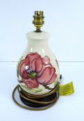 MOORCROFT POTTERY TABLE LAMP with circling tube-lined flowers against a cream ground, with wooden