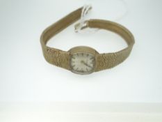 LADIES VINTAGE BULOVA BRACELET WRISTWATCH in 9ct yellow gold, the bracelet of tapered textured form,