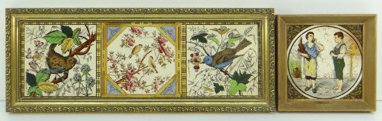 19TH CENTURY EARTHENWARE FRAMED TILE with circular depiction of two servant boys, one biting an