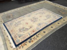 TWO PALE BLUE WOOLEN WASHED CHINESE RUGS with flower and dragon designs, 220 x 122cms and 250 x