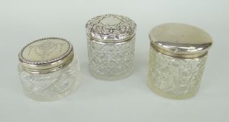 THREE VARIOUS SILVER LIDDED VINTAGE GLASS DRESSING TABLE JARS each with clear hallmarks, one