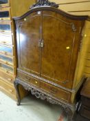REPRODUCTION BURR WALNUT DOME TOP COCKTAIL CABINET with two-drawer base on raised cabriole legs