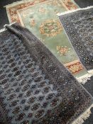 JADE GREEN CHINESE WASHED WOOLEN RUG with a rust floral border, 140 x 200cms together with two