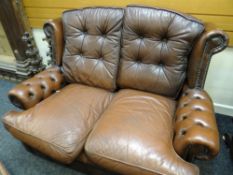 SMALL BROWN LEATHER TWO SEATER CLUB-STYLE WING BACK SOFA