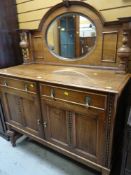 VINTAGE OAK MIRROR BACKED SIDEBOARD on raised feet with two drawers above two cupboards, 122cms