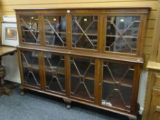 GOOD QUALITY REPRODUCTION MAHOGANY STEPPED TWO-TIER BOOK CASE with astragal glazed doors on raised