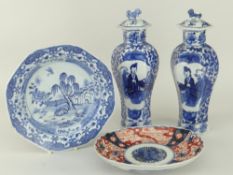 PAIR OF CHINESE UNDER-GLAZED BLUE PORCELAIN VASES of faceted baluster form with narrow necks and