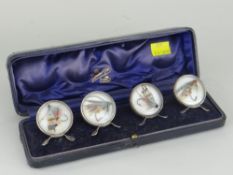 SET OF FOUR SILVER FRAMED MENU CARD HOLDERS each with fly-fishing hooks in glazed circular panels