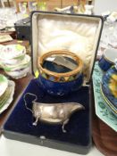 A HALLMARKED SILVER CREAMER together with a Doulton Lambeth tobacco jar